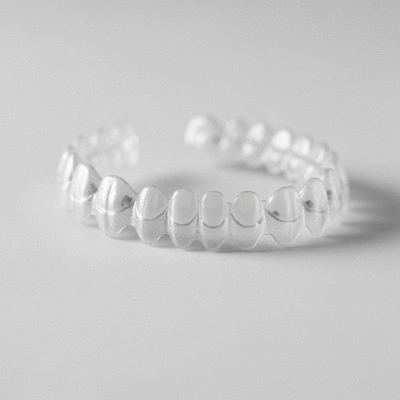 Close-up of clear aligners on a white background, no text, no words, no typography, clean image