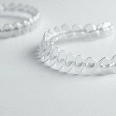 Close-up of transparent orthodontic aligners on a white background