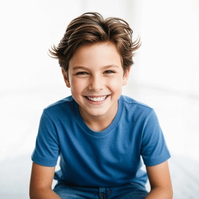 Child smiling confidently after orthodontic treatment
