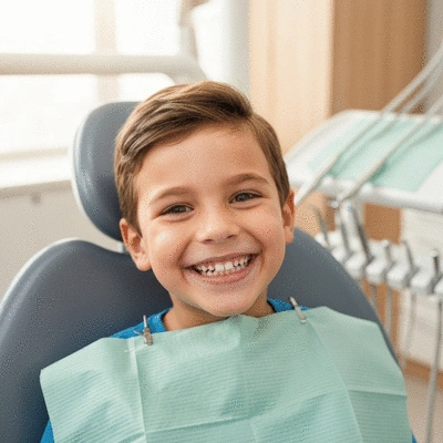 Child smiling with healthy, aligned teeth in a dental clinic setting